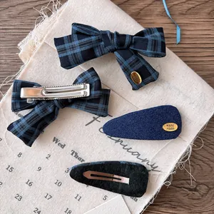 Navy plaid bow hair clip set with 4 pieces featuring handmade gold metal charms on wood