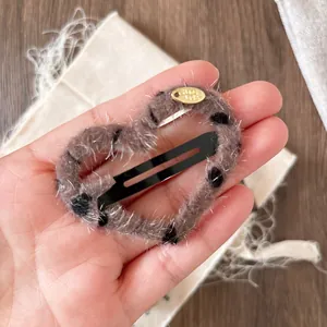 Leopard print heart-shaped plush hair clip with gold pendant for women and girls