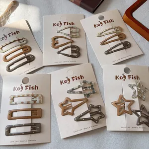 Three-piece set of brown checkered and polka dot hair clips for children on display card