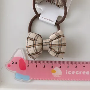 Paire de chouchous à nœuds en tissu à carreaux beige et marron avec élastiques