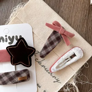 Pink plaid velvet bow hair clips and brown star barrettes with silver spring clips