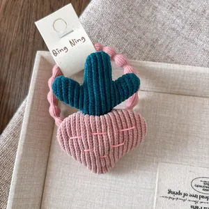 Detail of cute velvet carrot embroidery hair tie with pink elastic wave band