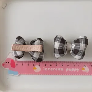 Détail de barrettes à carreaux avec clips métalliques recouverts de ruban marron