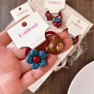 Cute children's hair ties with blue flowers and brown bear resin charms in 2-piece set