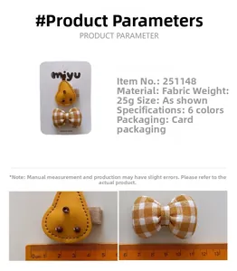 Close-up showing a 6cm yellow fabric bow and 4cm clip with a measuring ruler for scale