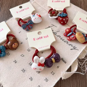 Detailed view of red elastic hair ties for kids with cute resin cartoon charms set