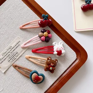 Close-up of 5-piece cute cartoon hair clips set with cherry and animal resin shapes