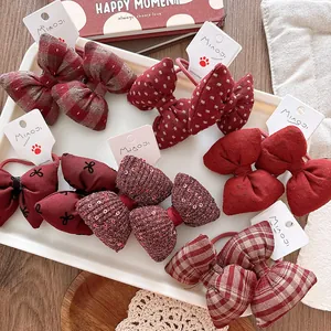 Detailed view of red plaid and polka dot bow hair ties on display cards for girls