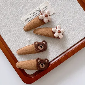 4pcs cute brown teddy bear and checkered flower hair clips for kids on linen background
