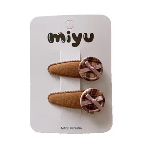 Brown drop-shaped children's hair clips with plaid buttons and pink bows, set of two