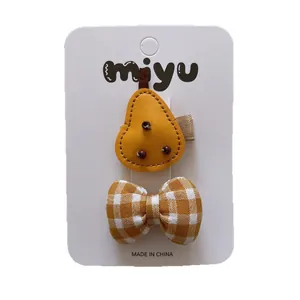 Set of 2 yellow kids hair clips featuring leather pear design and checkered fabric bow