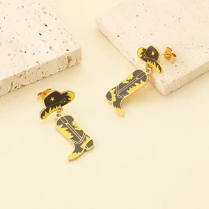 Detailed macro shot of trendy gold-plated cowboy hat and boot enamel dangle earrings