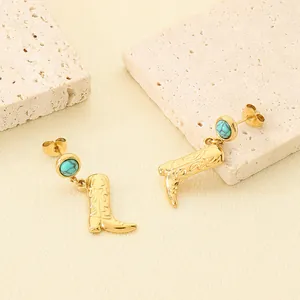 Detailed view of gold stainless steel cowboy boot earrings featuring turquoise stones