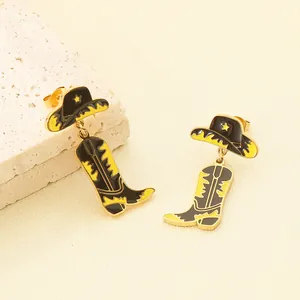 Close-up of stainless steel cowboy hat and boot earrings with yellow enamel detail.