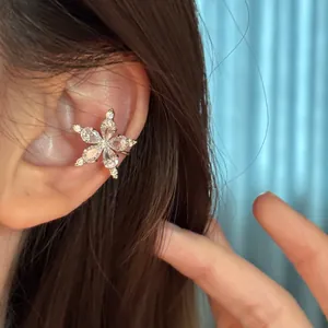 Close-up view of a sparkling star-shaped ear cuff with clear cubic zirconia stones