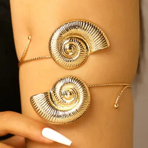 Detail showing golden spiral seashell adjustable upper arm cuff for beach vacation