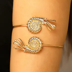 Close-up of an adjustable gold nautilus shell arm cuff for beach vacation jewelry