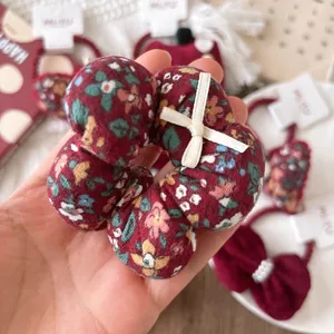 Vintage red floral velvet scrunchie for girls featuring a sweet bow and flower pattern