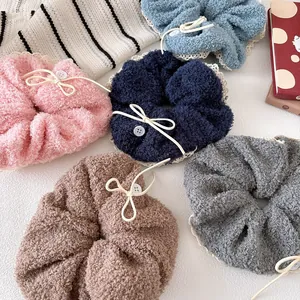 Flat lay of colorful plush hair scrunchies with lace trim and bow knot detailing