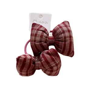 Red plaid bow hair ties set for kids featuring classic checkered fabric on display card