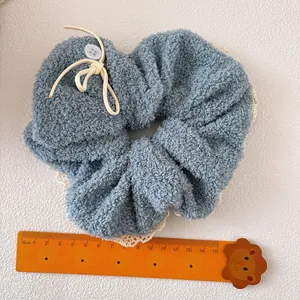 Large blue teddy plush hair scrunchie with white lace trim and bow knot detail