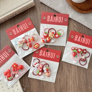 Close-up of cute cartoon hair ties set with resin animals and fruits in gift packaging