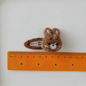Cute brown plush bear hair clip for girls featuring soft curly fabric and 5cm BB clip