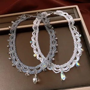 Close-up detail of vintage beaded lace necklaces featuring blue and iridescent glass crystals