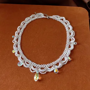 Close-up of elegant vintage beaded lace necklace featuring shimmering crystal drops