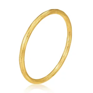 Minimalist gold stainless steel bangle featuring fine horizontal embossed textures