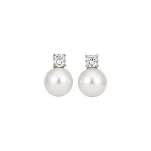 Elegant silver stud earrings with round zircon and white cat eye stone on white background.