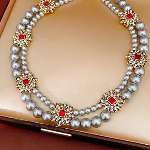 Elegant vintage double-layer grey pearl necklace featuring crystal flower charms in a box