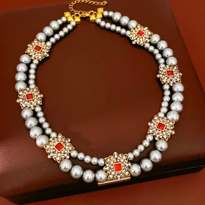 Macro view of vintage double-layered pearl necklace with rhinestone flower accents
