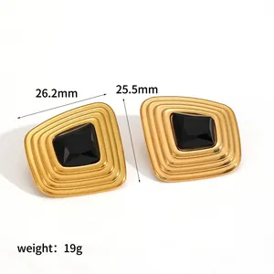 Detailed shot of French vintage gold-plated stainless steel earrings with black stones