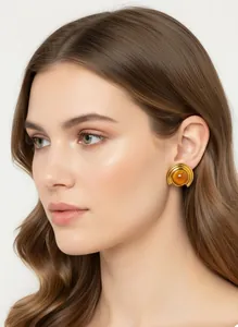 Close-up of a model wearing a French vintage gold stud earring with a central amber stone.