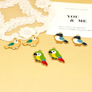 Detailed close-up view of colorful enamel parrot and bird charms for DIY jewelry making.