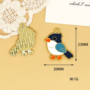 Detailed view of enamel bird charm pendant with dimensions 23mm by 20mm and weight 1g