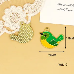 Detail view of bird enamel charm with 19mm x 24mm dimensions and gold textured back