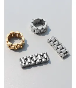 Macro shot of gold and silver stainless steel rings with classic watch band link texture