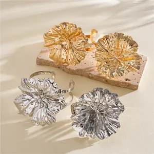 Detailed view of large wrinkled metal flower bracelets in elegant gold and silver finishes