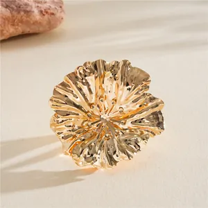 Detailed view of a golden metallic wrinkled flower ring with intricate petal textures