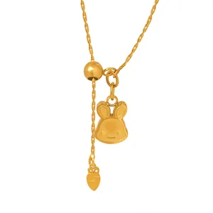Golden necklace with bunny and carrot pendants featuring adjustable sliding bead detail