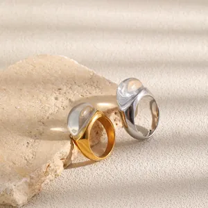 Primer plano de anillos gruesos de acero inoxidable bañados en oro y plata con resina