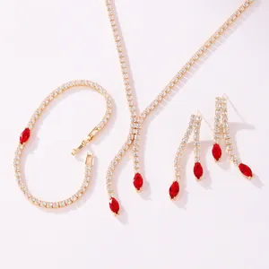 Detailed view of luxury gold-tone jewelry set with red marquise stones and zircons