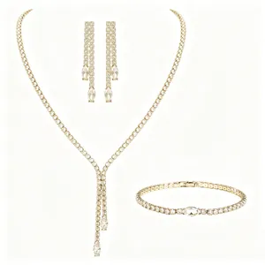 Detail view of luxury gold-tone jewelry set featuring marquise-cut cubic zirconia