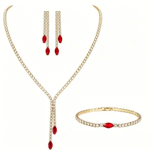 Elegant gold jewelry set with marquise red stones and white zircons for evening wear
