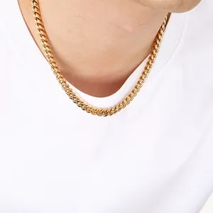 Detailed view of an 8mm gold-plated stainless steel Cuban link necklace worn on a neck.
