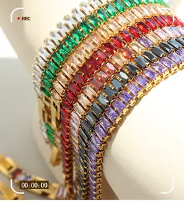 Macro detail of gold-plated bracelet featuring multi-color emerald cut zircon stones
