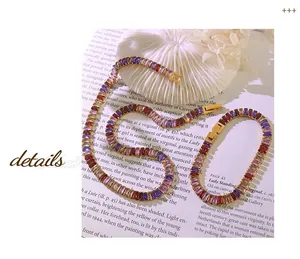 Detailed macro view of gold plated tennis necklace and bracelet set with colorful zircons