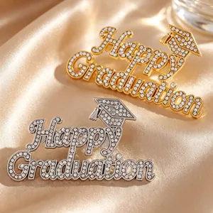 Detailed view of Happy Graduation pins with crystal embellishments and cap motifs